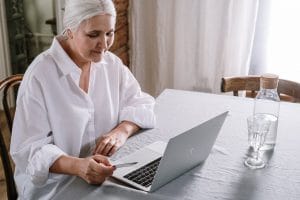 an old woman using a laptop